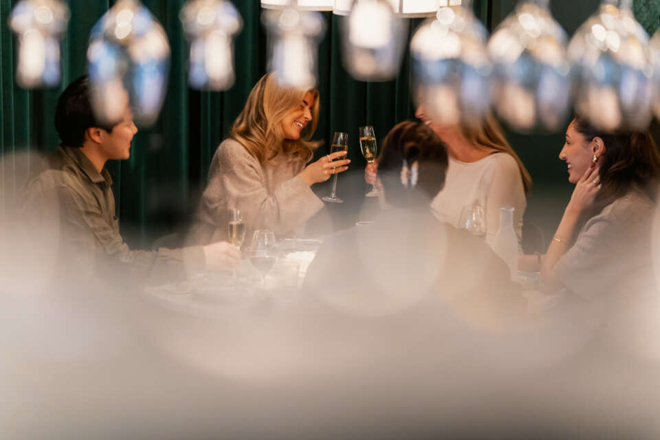 PGuests toasting with sparkling wine at Upper House